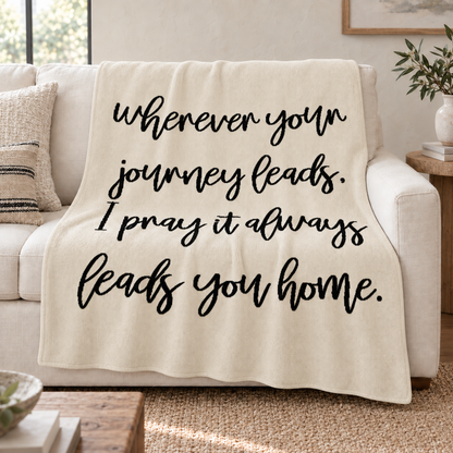 Natural Wherever Your Journey knit throw draped over an ivory sofa.