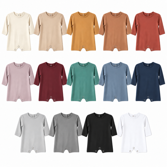 Fourteen solid-color long sleeve baby rompers, evenly sized on white