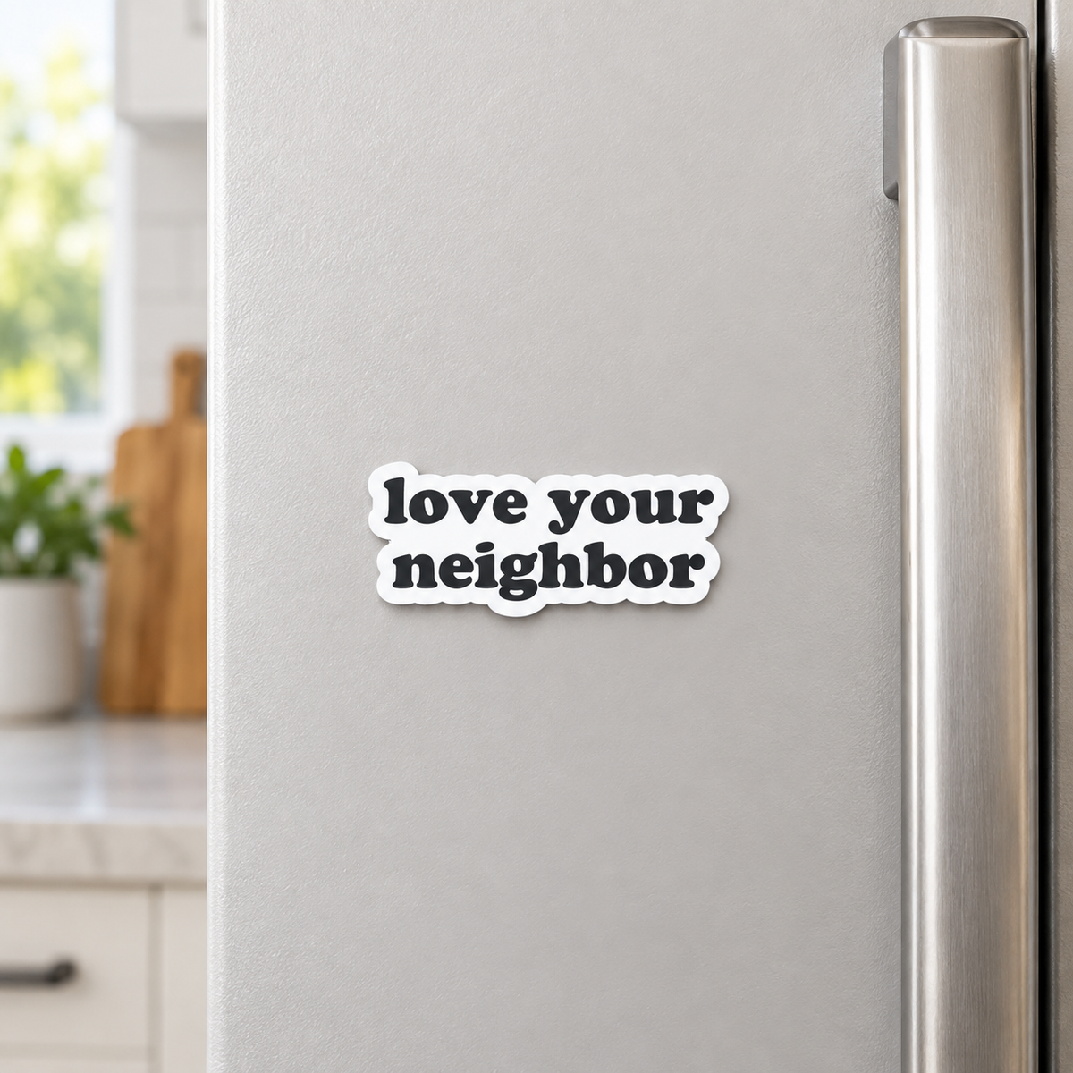 AI-styled kitchen view of the Love your neighbor magnet on a refrigerator; one approximately 2.33 by 1 inch magnet sold separately.