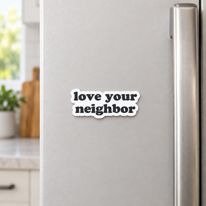AI-styled kitchen view of the Love your neighbor magnet on a refrigerator; one approximately 2.33 by 1 inch magnet sold separately.