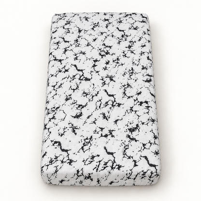 Marble organic crib sheet shown fully fitted with black veining on white muslin