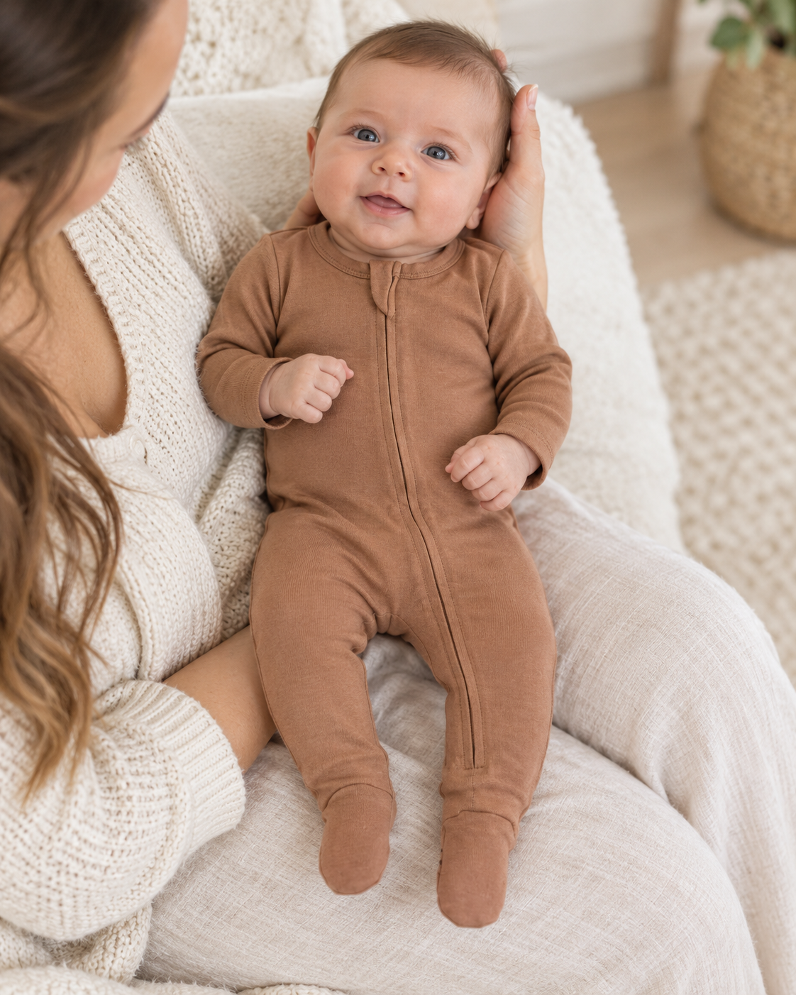 AI-styled lifestyle view of Organic Baby Two-Way Zip Footie | Newborn–6 Months in Mocha Mousse