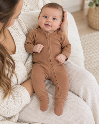 AI-styled lifestyle view of Organic Baby Two-Way Zip Footie | Newborn–6 Months in Mocha Mousse