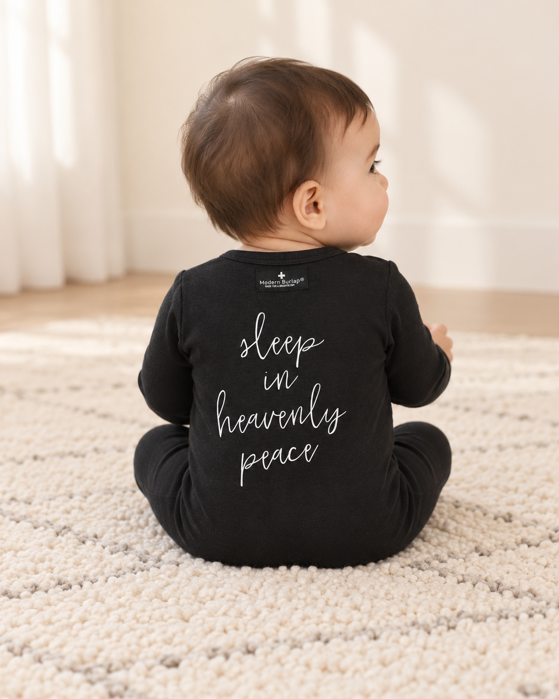 Baby showing the back design of Sleep in Heavenly Peace Button Footie; AI-styled product image.