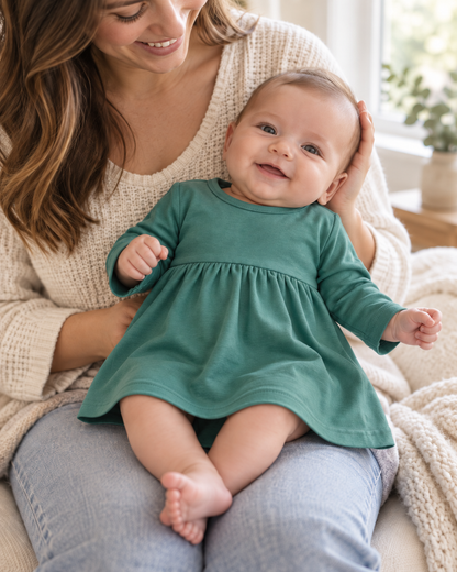 AI-styled lifestyle view of Organic Baby + Kids Long Sleeve Dress | Solid Colors in Pine Green