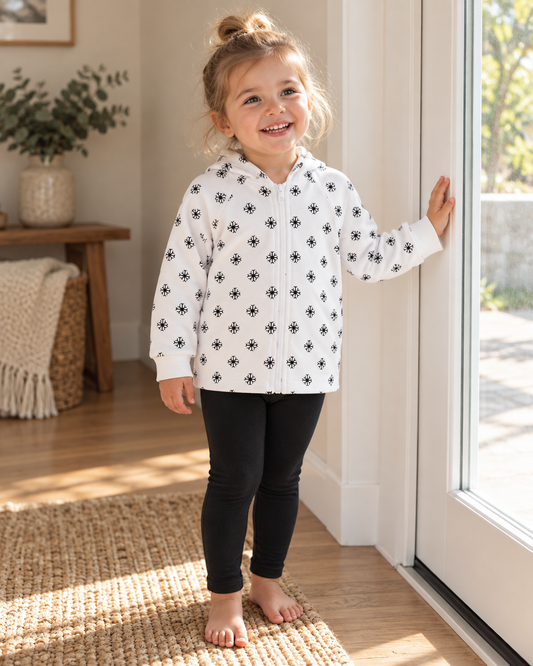 AI-styled lifestyle view of Organic Baby + Kids Zip Hoodie | Signature Prints in Black on White Snowflakes