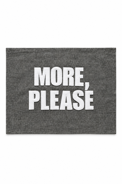 Graphite linen placemat with ivory More Please lettering. One placemat.