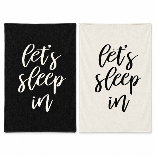 Let's Sleep In blankets in Black and Natural, shown together on white.