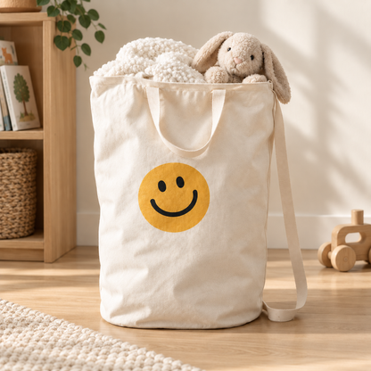 Smiley Face canvas bag holding a blanket and soft toy in a bright playroom.