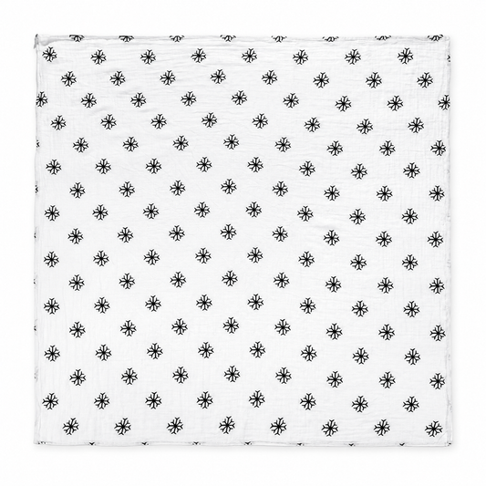 Snowflakes organic cotton muslin swaddle laid fully open, showing the square shape, black snowflake print and stitched edges on a white studio background.
