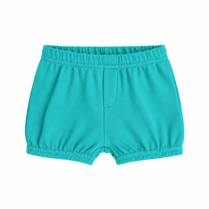 Modern Burlap organic baby and toddler shorts in Arcadia, front studio view with faux fly and gathered hems on white
