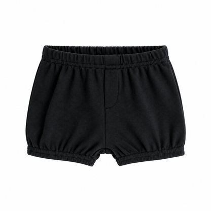 Modern Burlap organic baby and toddler shorts in Black, front studio view with faux fly and gathered hems on white