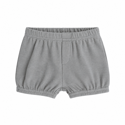 Modern Burlap organic baby and toddler shorts in Neutral Gray, front studio view with faux fly and gathered hems on white