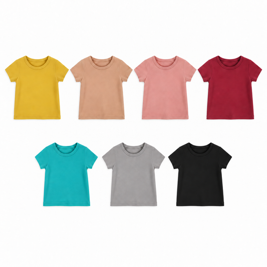 Seven Modern Burlap solid-color organic tees shown at matching scale: Mustard, Ginger, Blooming Dahlia, Maroon, Arcadia, Neutral Gray and Black.