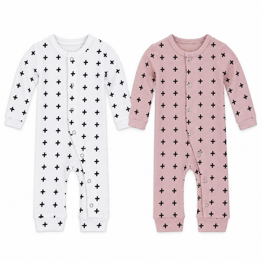 White and pink Swiss Cross organic thermal coveralls shown side by side on white, with front snaps and open ankle cuffs.