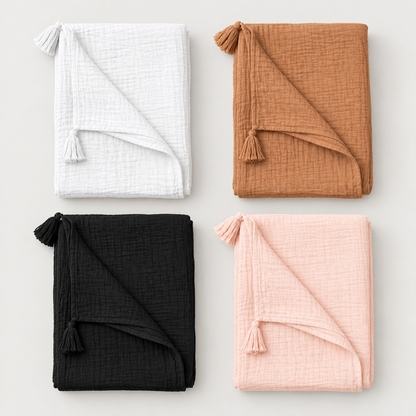 White, Ginger, Onyx and Dusty Pink organic cotton muslin tassel throws folded at equal scale; sold individually