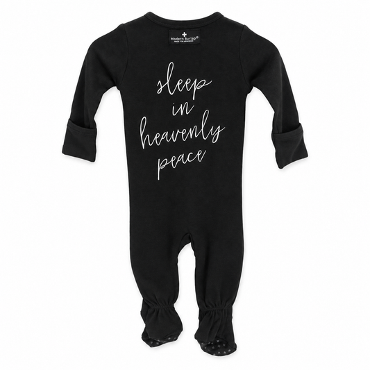 Black Sleep in Heavenly Peace organic button footie with covered feet, back view with white hymn lettering.