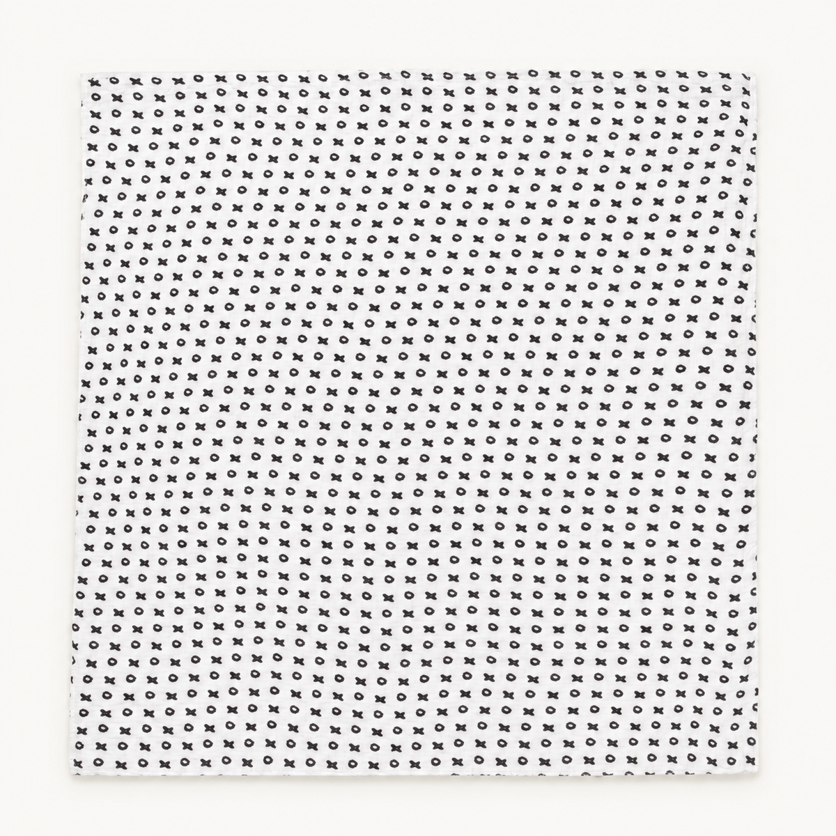 XO organic muslin swaddle laid flat, showing its complete black and white print.