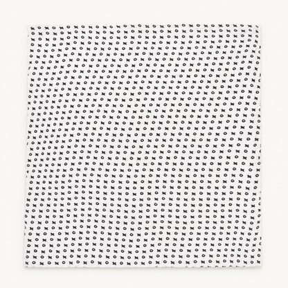 XO organic muslin swaddle laid flat, showing its complete black and white print.