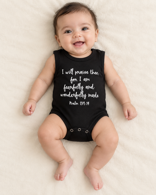 Baby wearing a black sleeveless tank bodysuit with the white Psalm 139:14 scripture design; AI-styled product image.