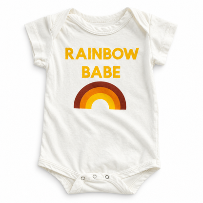 Ivory Rainbow Babe organic cotton bodysuit with yellow lettering, a red, orange and yellow rainbow, short sleeves and three bottom snaps.