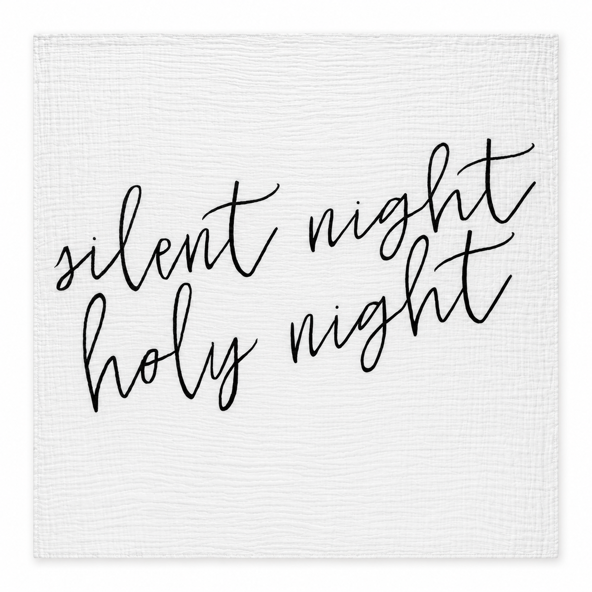 Silent Night Holy Night white muslin swaddle laid fully open on white, showing black hand lettering and stitched square edges.