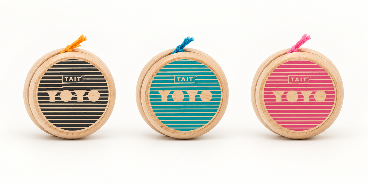 Black, teal, and pink Sling-Slang wooden yo-yos shown full-size together