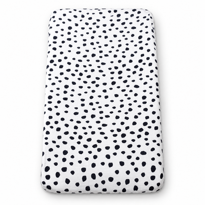 Spots organic changing pad cover fitted on a rectangular pad, shown on white.