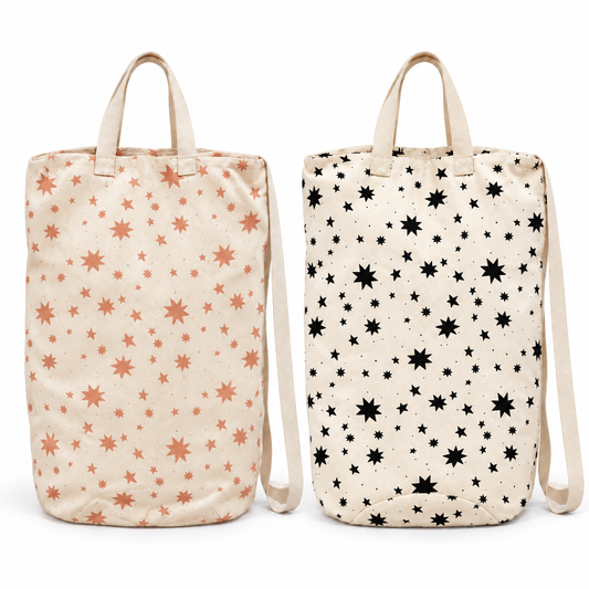 Sunburn and Black Starburst canvas laundry bags shown together at matching scale on white; bags sold individually