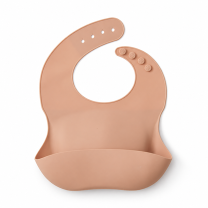 The Saturday Baby silicone bib in Peach on white, front studio view.
