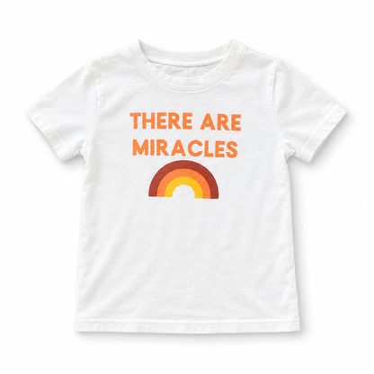 White There Are Miracles kids tee with orange lettering and a three-color rainbow, full front studio view