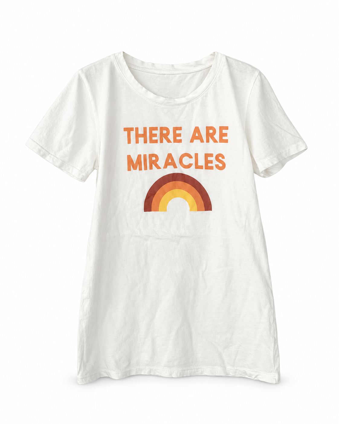 White There Are Miracles organic women's tee with orange lettering and a warm red, orange and yellow rainbow, shown from the front on a white background.