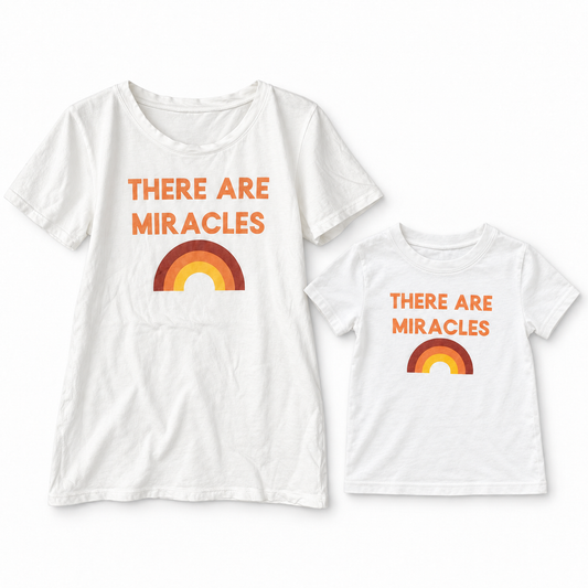 There Are Miracles adult and kids' tees together in a studio flat lay; each tee sold separately.