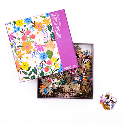 Oopsie Daisy puzzle open box and puzzle pieces