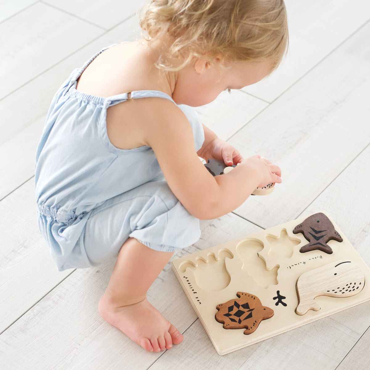 Child playing with the Ocean Animals wooden tray puzzle