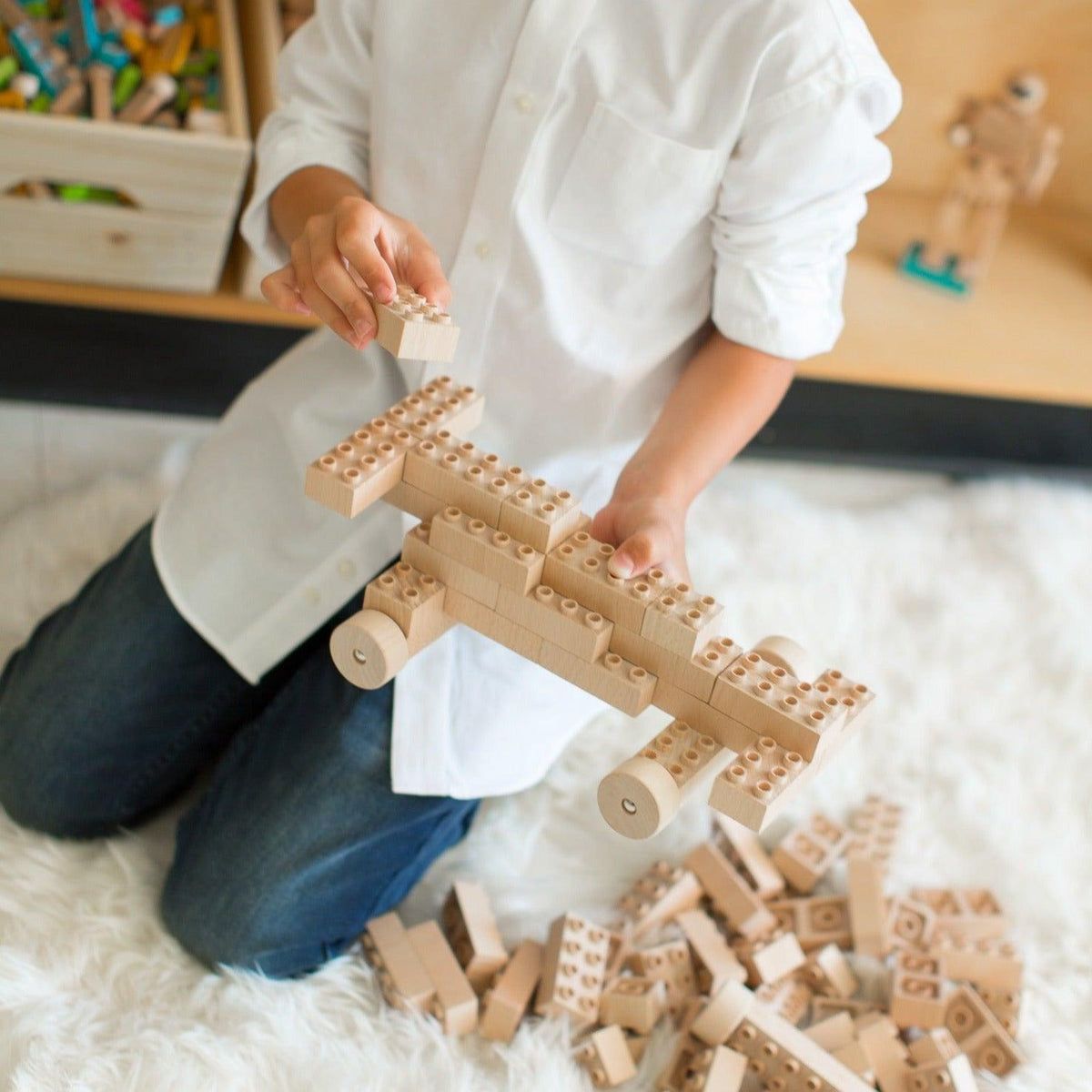 Child building with Eco-Bricks PLUS wooden bricks