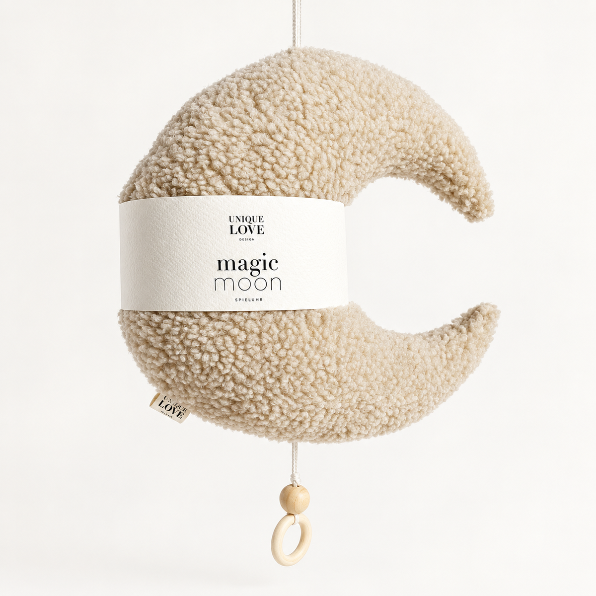 Cream Magic Moon music box with teddy texture and wooden pull ring.