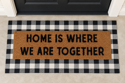 XL Doormat | Home Is Where We Are Together layered over a black and ivory buffalo plaid runner at a black door.