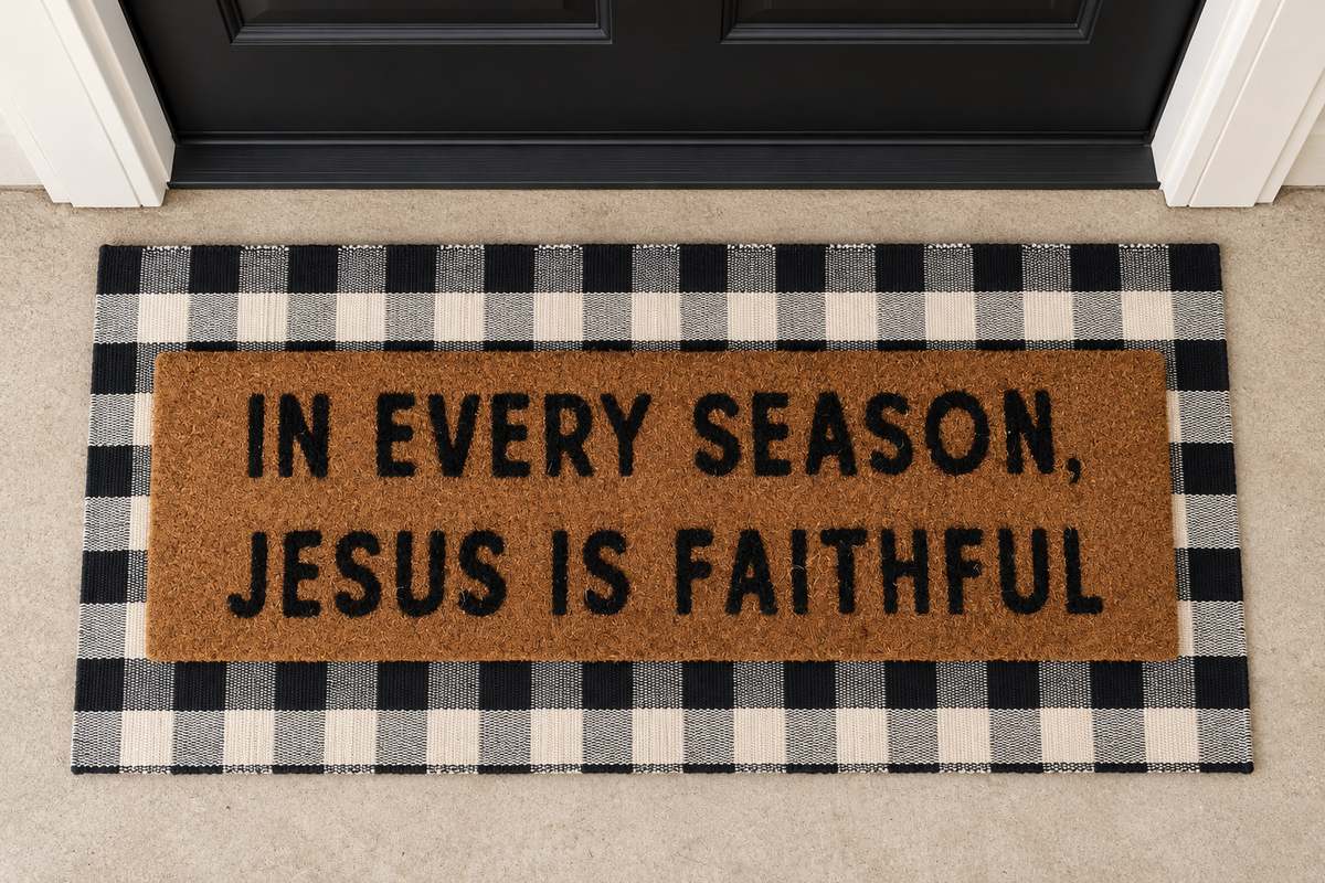 In Every Season, Jesus Is Faithful XL doormat layered over the buffalo plaid runner at a black front door.