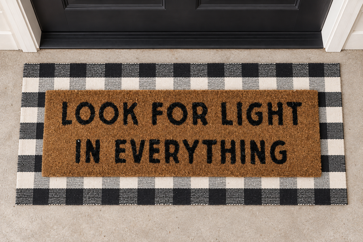XL Doormat | Look for Light in Everything layered over a black and ivory buffalo plaid runner at a black door.