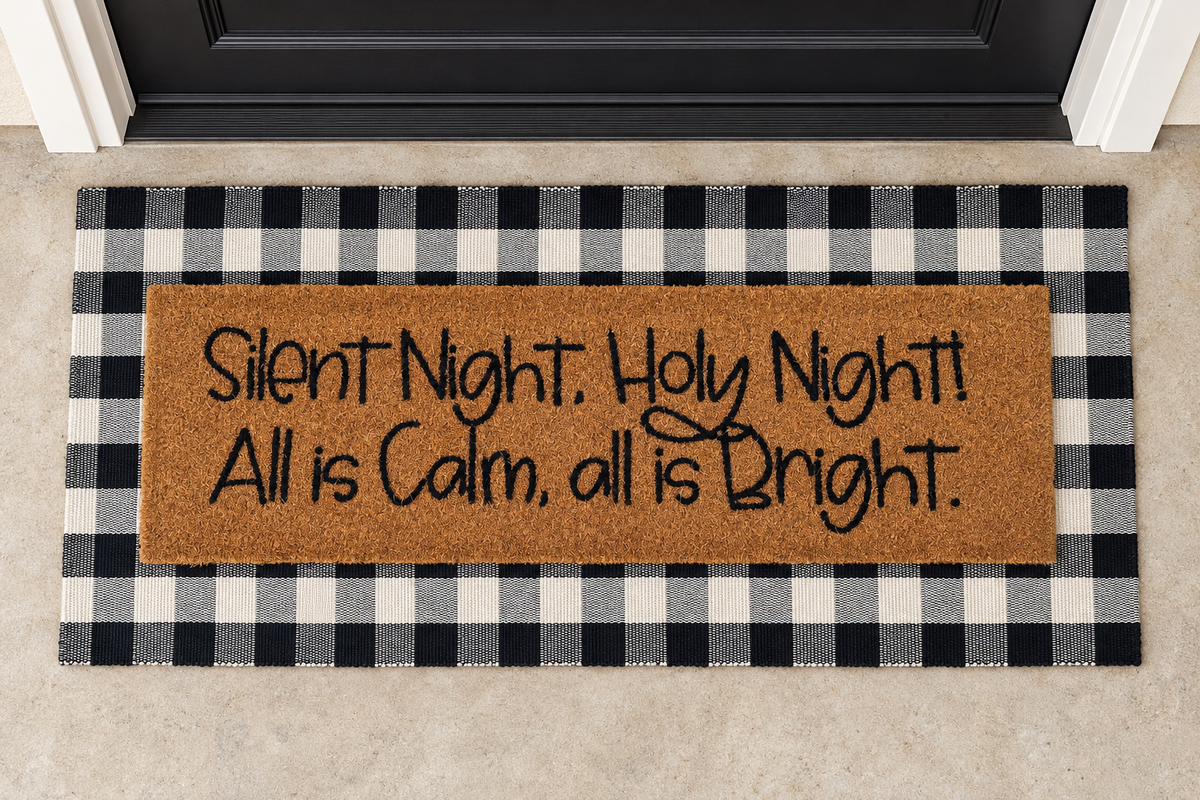 XL Christian Doormat | Silent Night Holy Night layered over a black and ivory buffalo plaid runner at a black door.