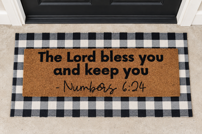 XL Scripture Doormat | Numbers 6:24 layered over a black and ivory buffalo plaid runner at a black door.