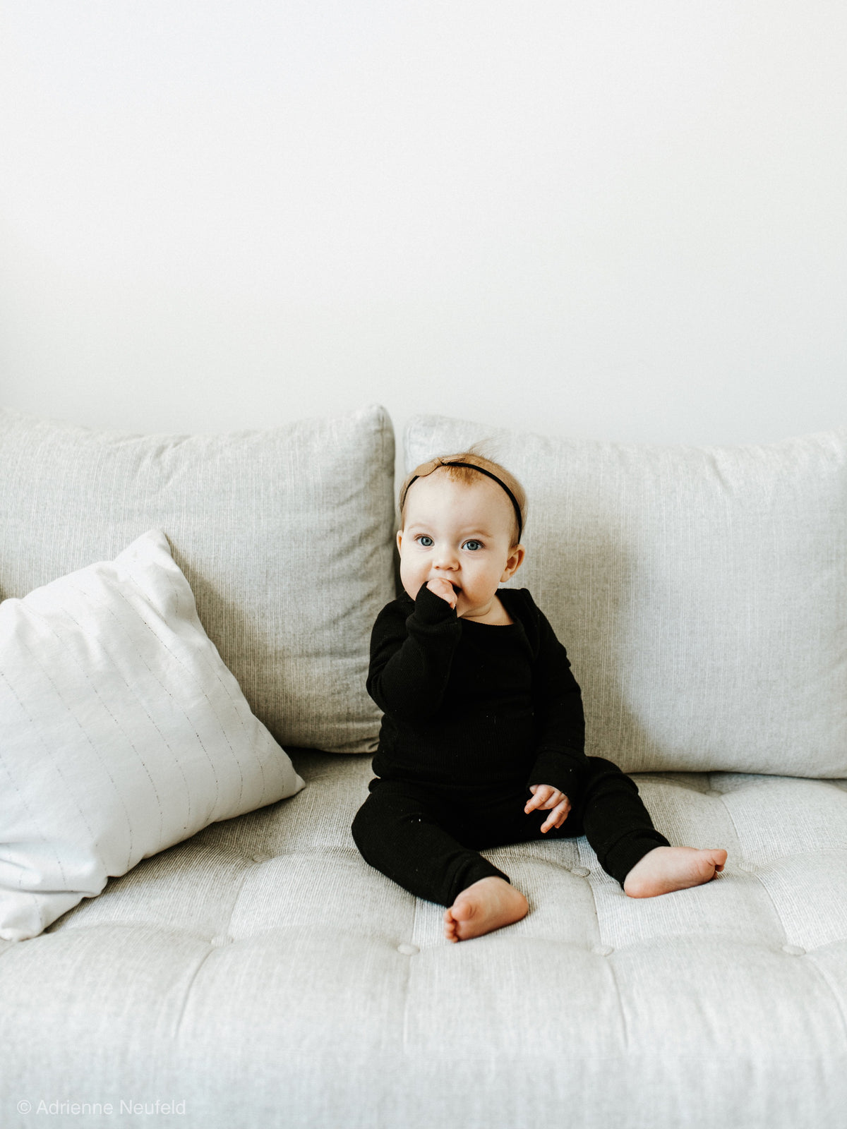 Organic Baby + Kids Pajama Set | Black — Baby seated in black pajamas