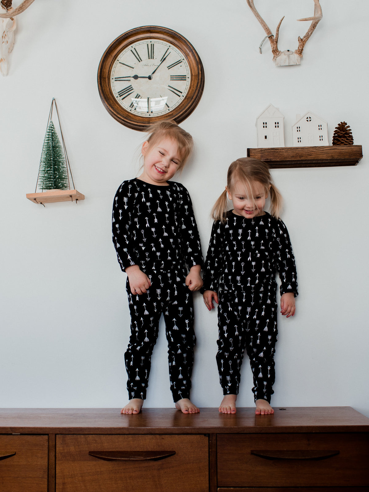 Organic Baby + Kids Pajama Set | White on Black Arrows — Full-length view of children in matching arrow pajamas