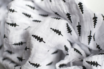 Fabric and print detail of Trees Organic Swaddle.