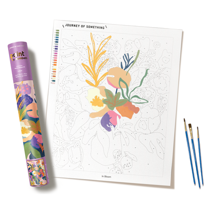 In Bloom paint-by-numbers kit showing floral canvas, paintbrushes and storage tube.