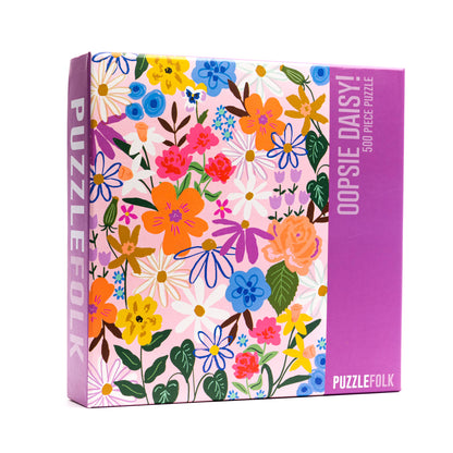 Puzzlefolk Oopsie Daisy 500-piece puzzle box featuring colorful flowers.