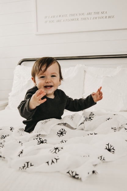 Snowflakes organic cotton muslin swaddle by Modern Burlap