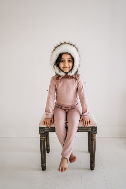 Organic Baby + Kids Pajama Set | Mauve — Child wearing the set seated on a stool