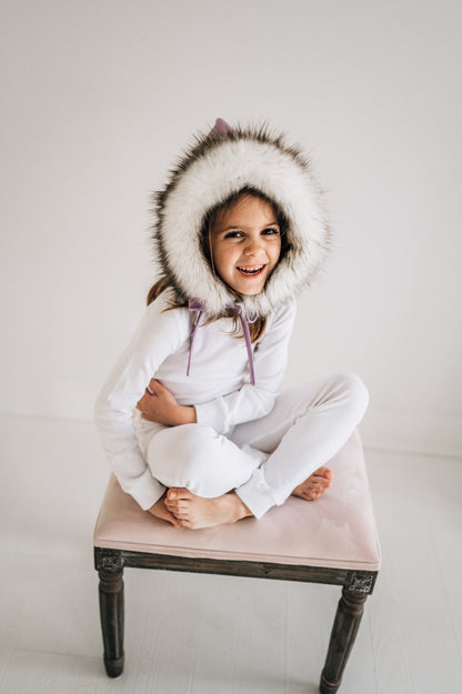 Organic Baby + Kids Pajama Set | White — Child wearing white pajamas seated on a stool